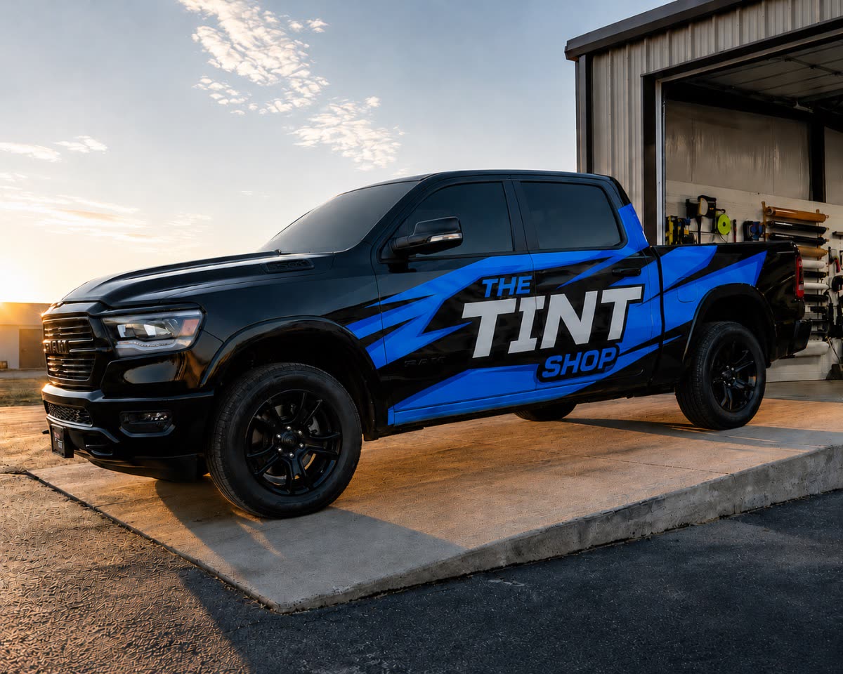Black Ram pickup wrapped in blue and white The Tint Shop fleet graphics